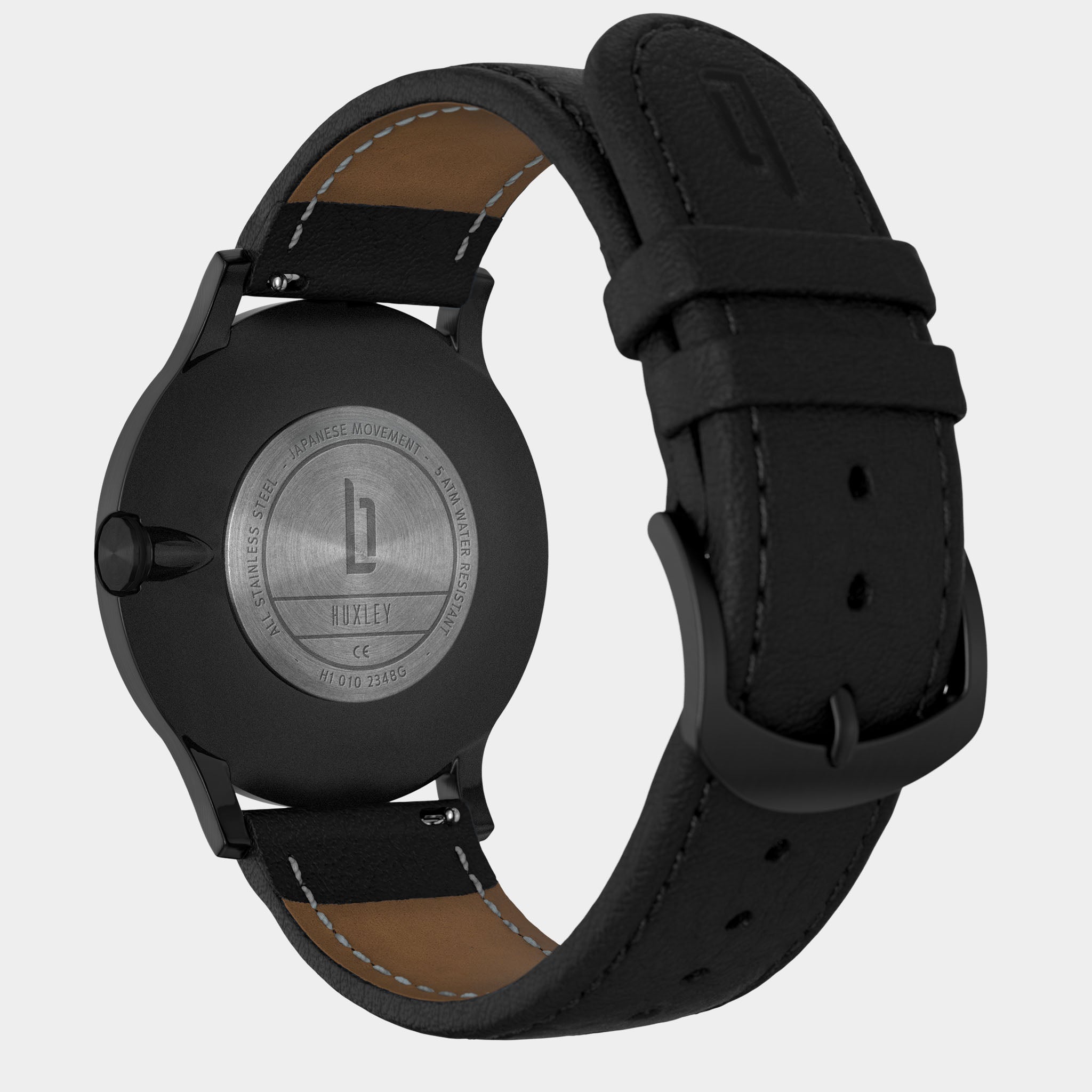 Back view of a black stainless steel watch with leather strap and engraved caseback