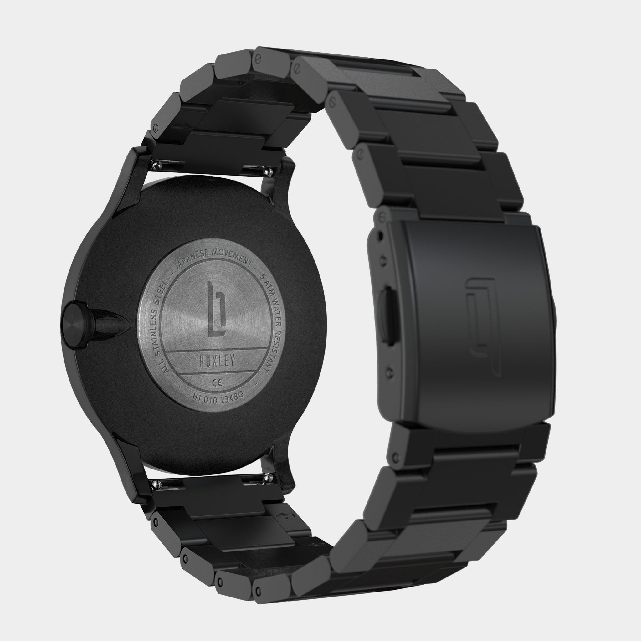 Back view of a black stainless steel wristwatch with engraved case and metal strap