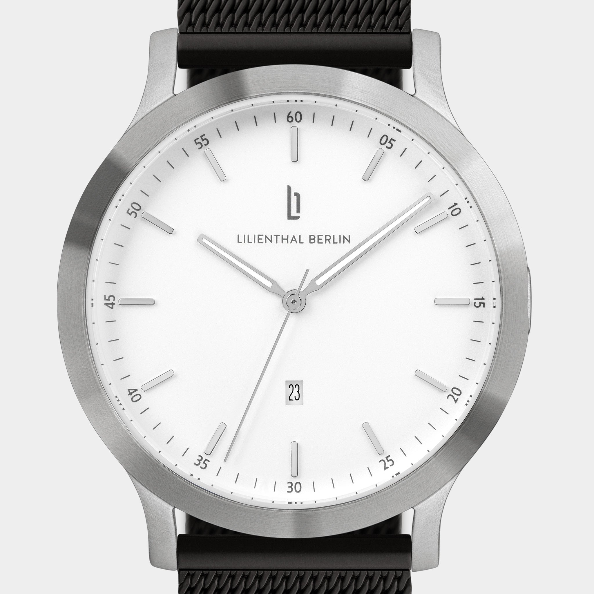 Minimalist silver wristwatch with white dial, mesh strap, and date display at 6 o'clock