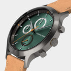 Green chronograph watch with brown leather strap and silver case on white background