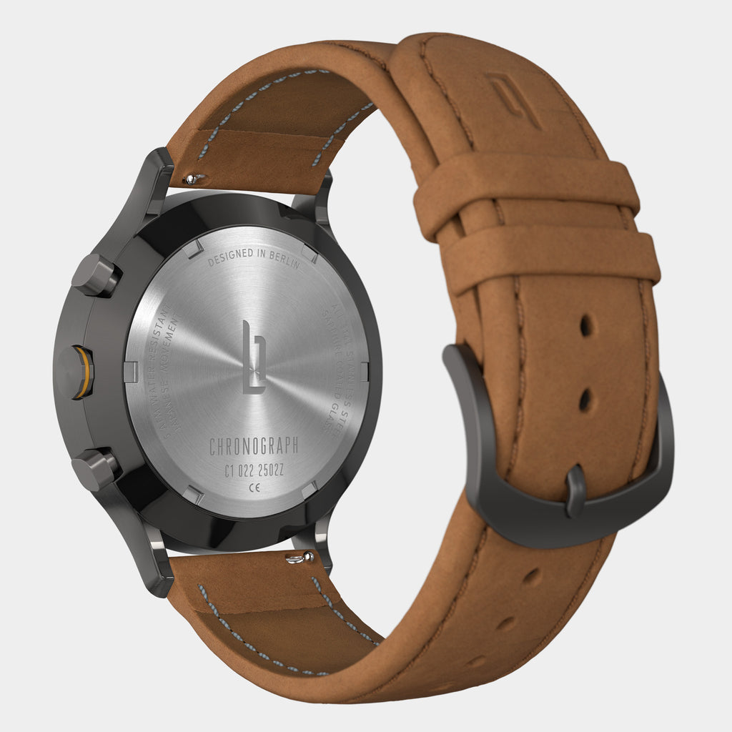 Chronograph watch with brown leather strap, stainless steel back, and black hardware
