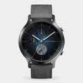 Modern analog wristwatch with blue dial, chronograph subdials, date display, and grey strap