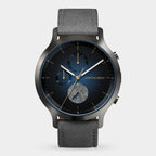 Modern analog wristwatch with blue dial, chronograph subdials, date display, and grey strap
