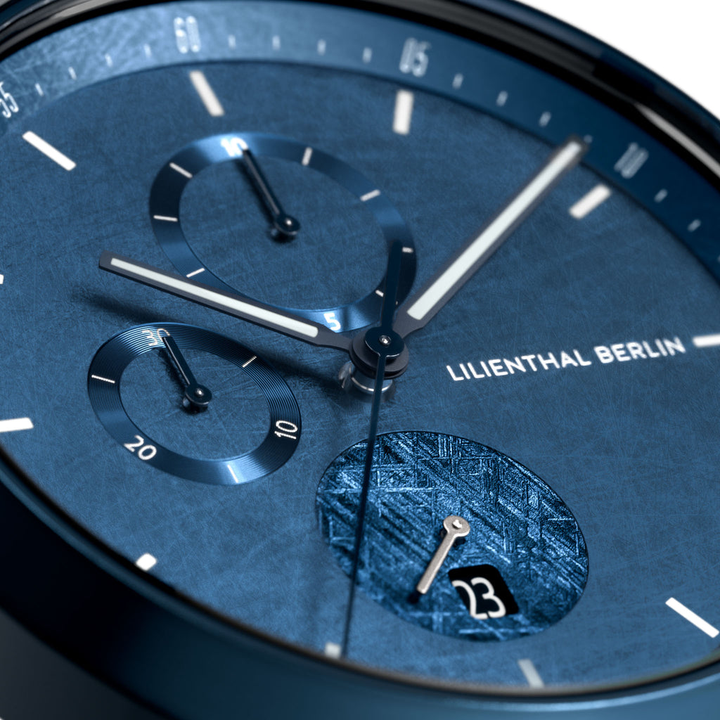 Close-up of blue dial chronograph watch with date display and textured subdials