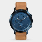 Blue chronograph watch with subdials, date display, and tan leather strap