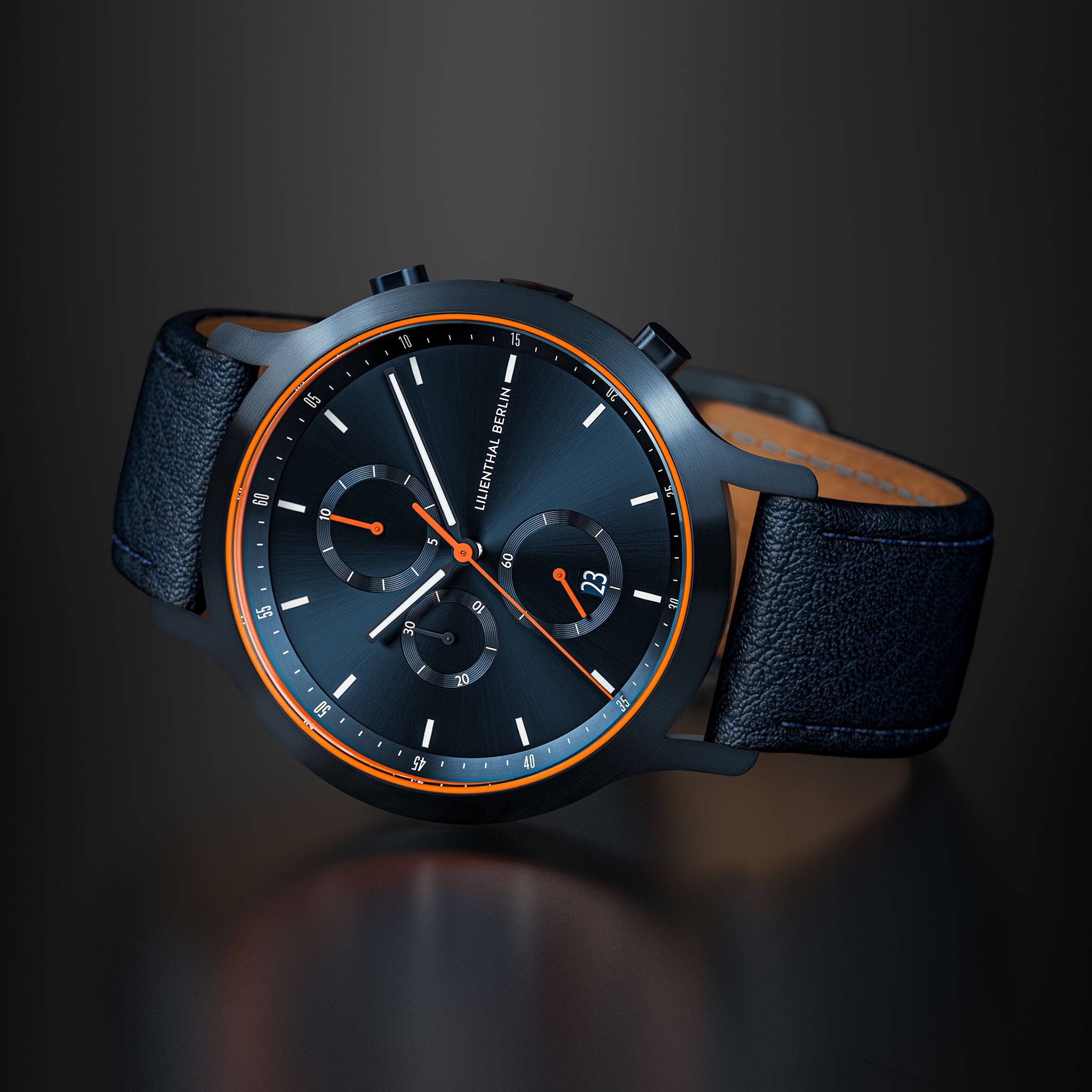 Modern black chronograph watch with orange accents and leather strap on a dark background