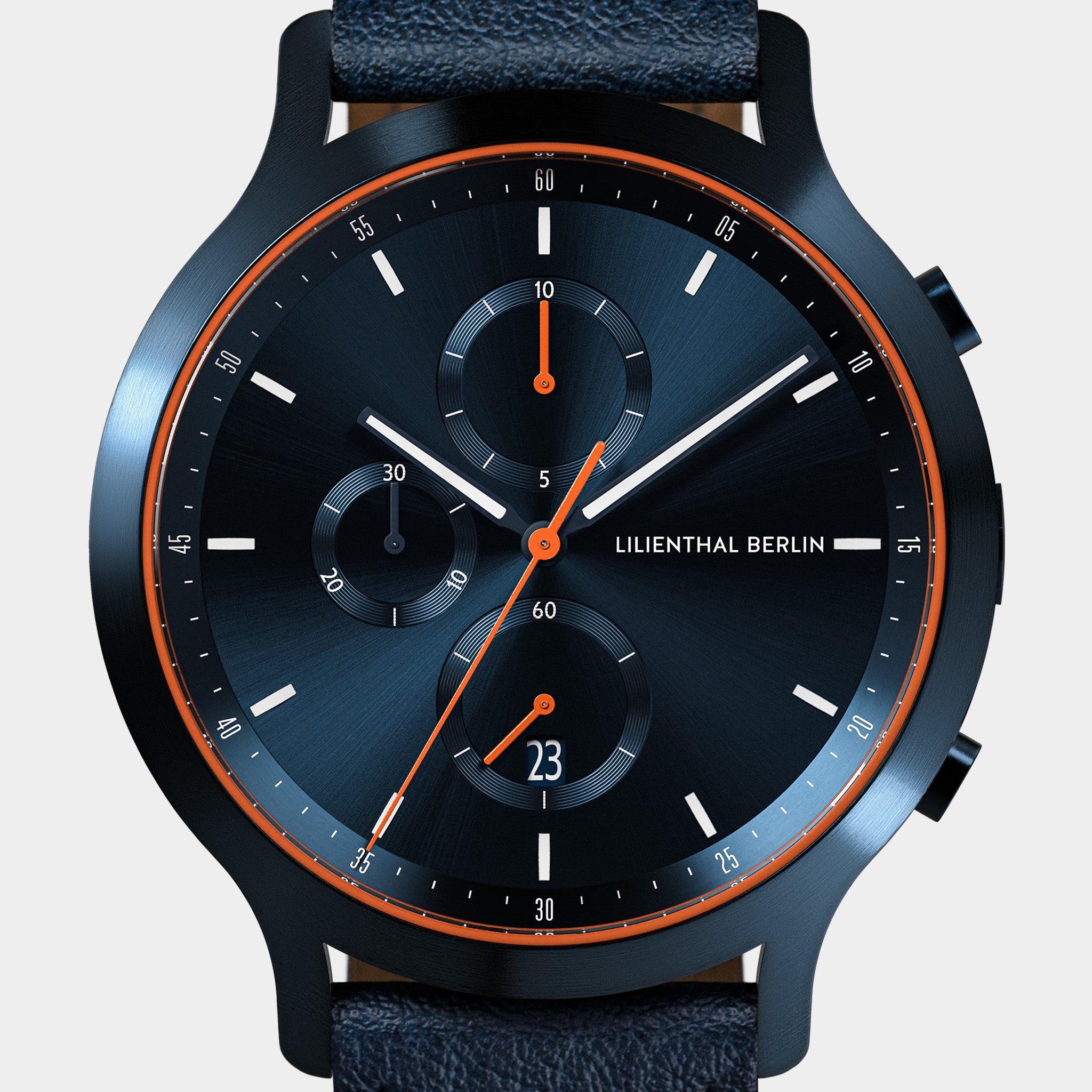 Modern chronograph watch with blue dial, orange accents, subdials and leather strap