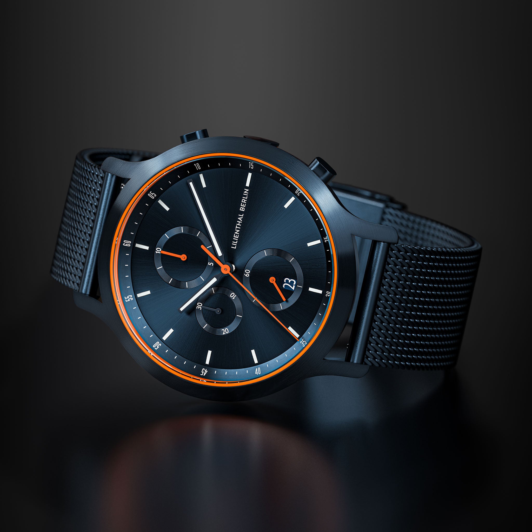 Black chronograph watch with mesh strap, orange accents, and sleek minimalist dial.