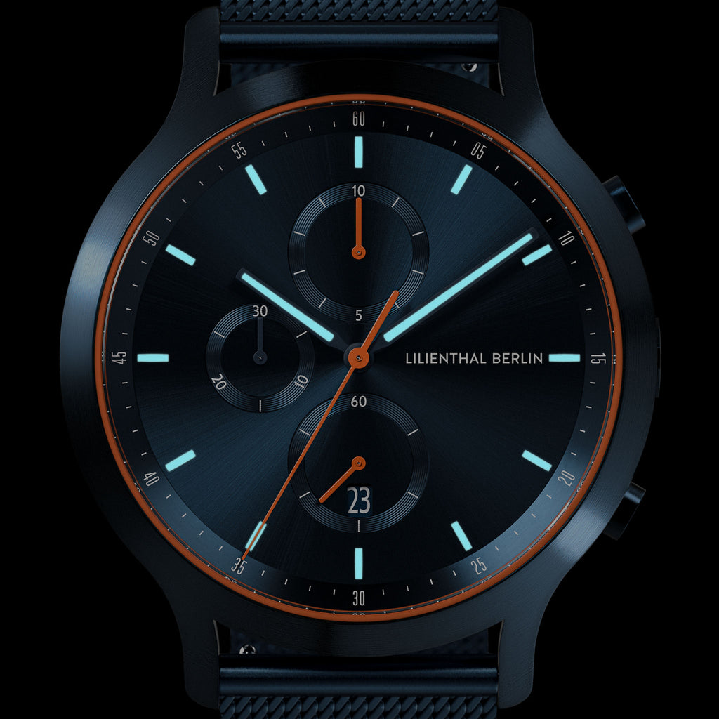 Black chronograph watch with orange detailing, sleek dial, and luminous hour markers