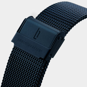 Black mesh stainless steel watch strap with engraved clasp on white background