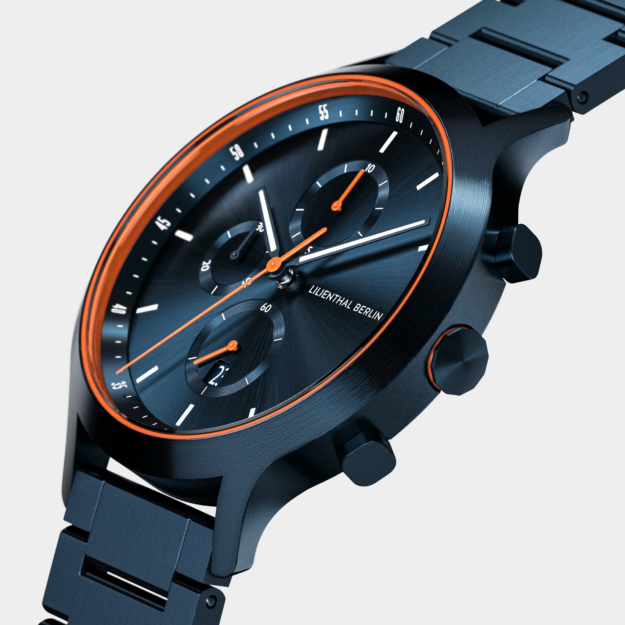 Close-up of black metal chronograph watch with orange accents and three subdials
