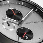 Close-up of a modern chronograph watch face with subdials, date display, and bold hands.