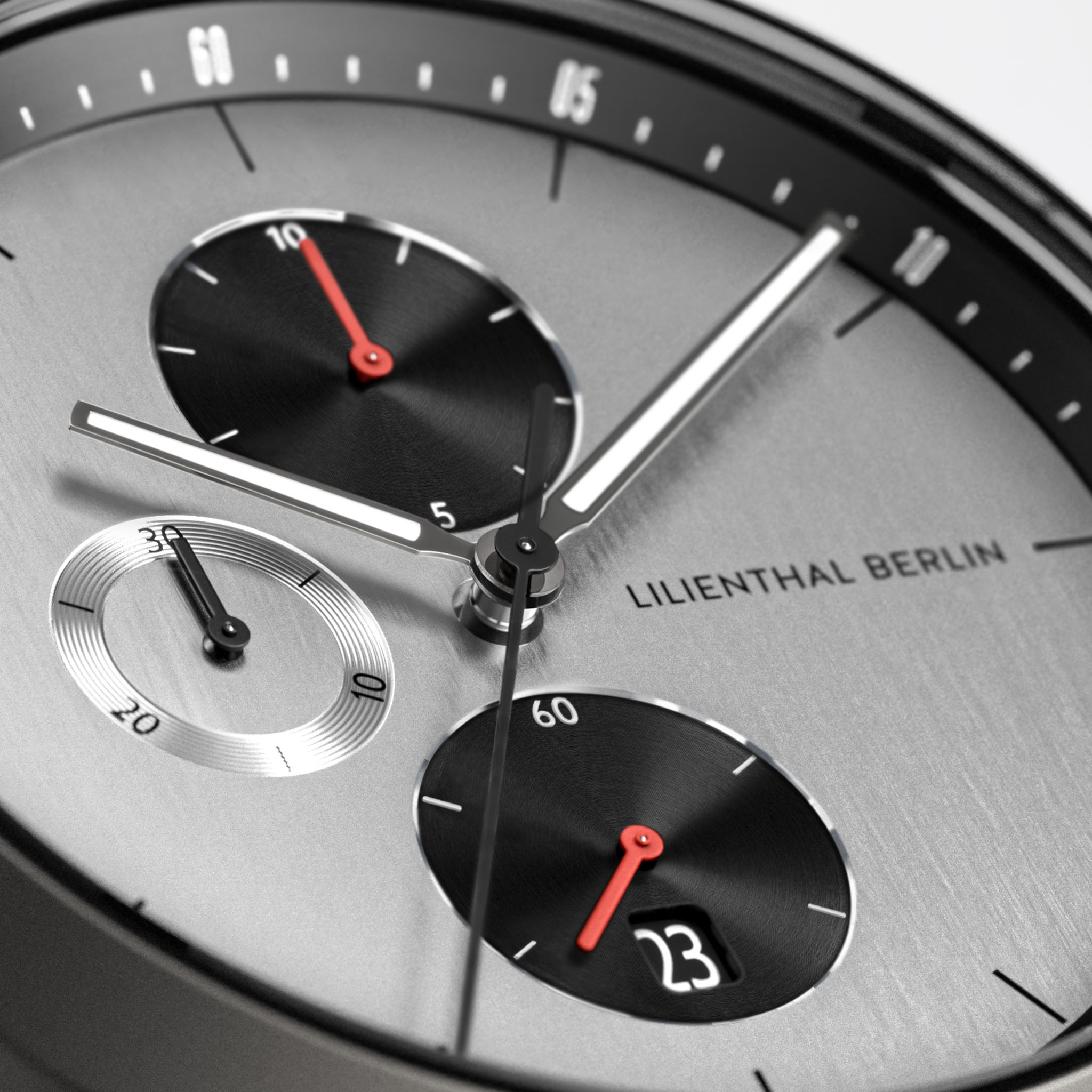 Close-up of a modern chronograph watch face with subdials, date display, and bold hands.