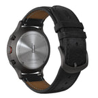 Close-up of a chronograph watch caseback with black leather strap and stainless steel details