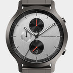 Modern chronograph watch with silver dial, black subdials, and red accents