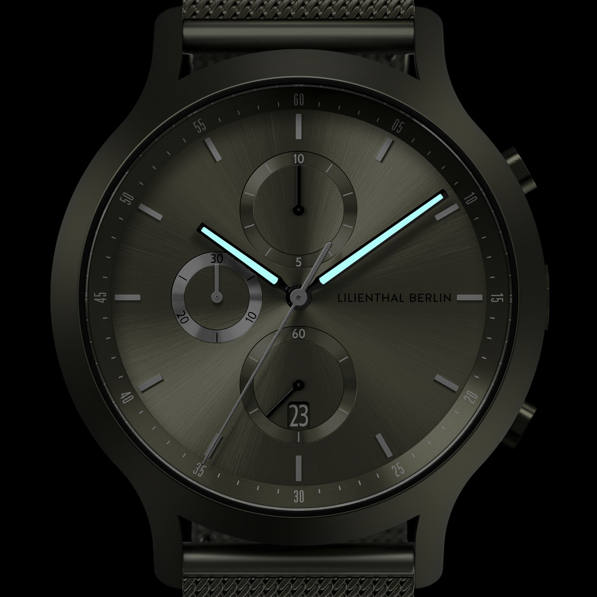 Modern black chronograph watch with illuminated hands, subdials, and mesh strap