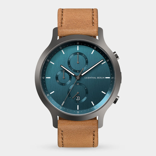 Modern wristwatch with blue dial, three subdials, date window and tan leather strap