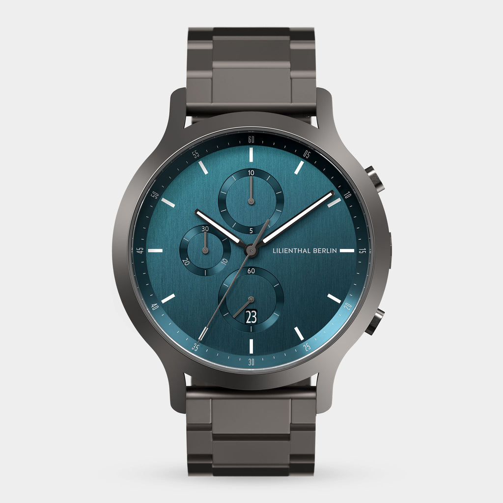 Modern stainless steel chronograph watch with blue dial and date display on a white background.