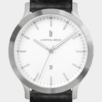 Minimalist silver watch with white dial, date display, and black leather strap