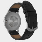 Back view of stainless steel watch with black leather strap and engraved case details