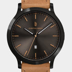 Brown sunburst dial wristwatch with date display and tan leather strap.