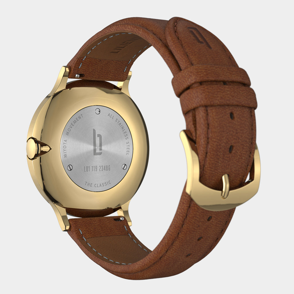 Back of gold stainless steel watch with brown leather strap and engraved caseback