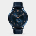 Elegant blue minimalist watch with rose gold hands and black leather strap on white background